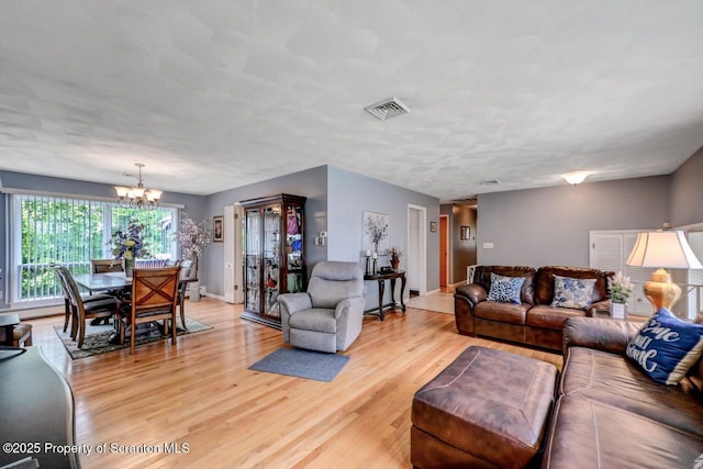 21 Leslie Dr, Scranton, PA 18505 - living area with light wood finished floors, a chandelier, and baseboards