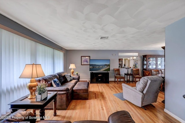 21 Leslie Dr, Scranton, PA 18505 - living area featuring a chandelier, light wood-type flooring, baseboards, and baseboard heating