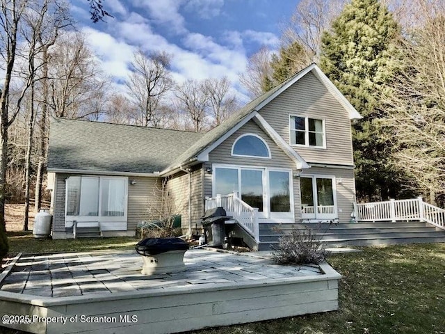 back of property featuring a wooden deck