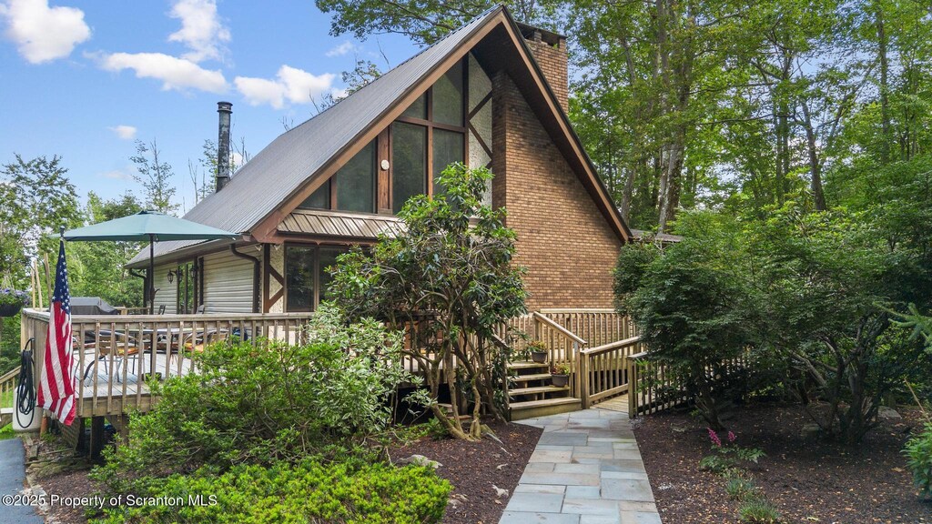 140 Living Waters Rd, Jefferson Twp, PA 18436 - view of front of home with a chimney, a wooden deck, and a metal roof