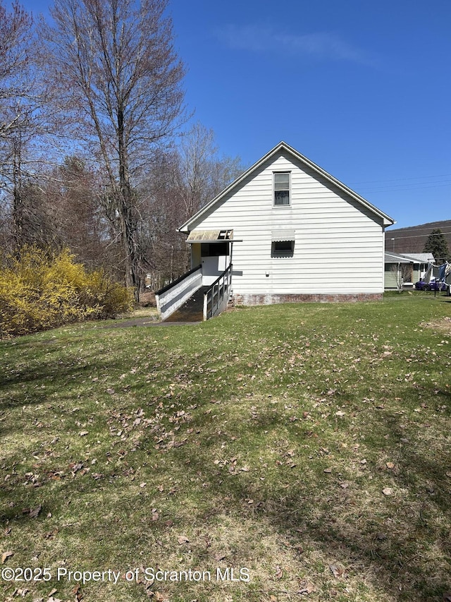view of home's exterior with a yard