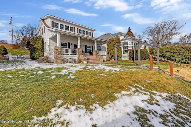 view of front of home with a front yard and covered porch