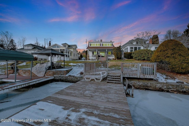 view of dock featuring a gazebo and a deck