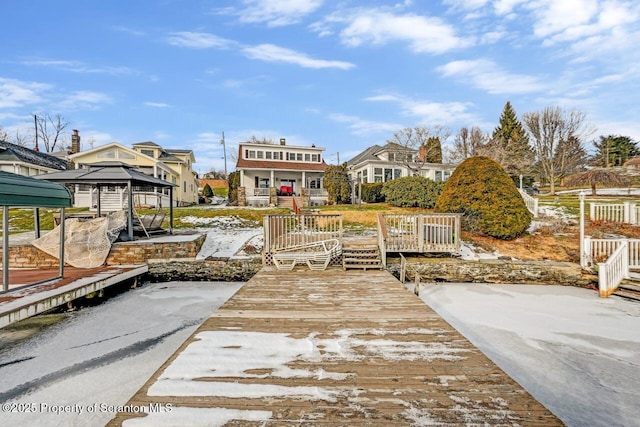 view of dock with a gazebo and a wooden deck