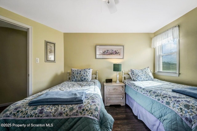 bedroom featuring ceiling fan and dark hardwood / wood-style floors