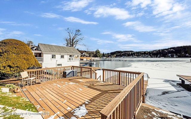 wooden terrace featuring a water view