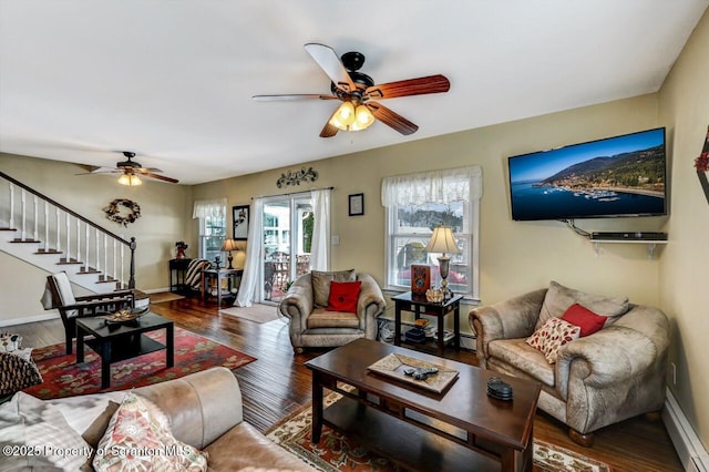 living room with ceiling fan, dark hardwood / wood-style flooring, and a baseboard heating unit