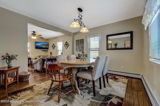 dining area featuring hardwood / wood-style floors, baseboard heating, and ceiling fan