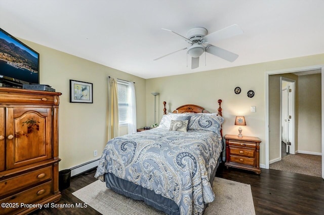 bedroom with a baseboard heating unit, ceiling fan, and dark hardwood / wood-style flooring