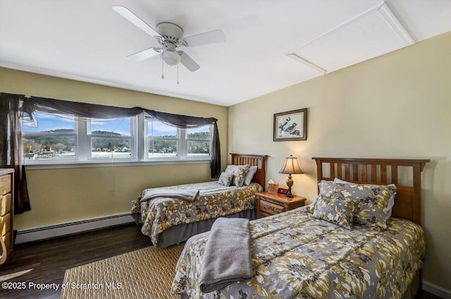 bedroom with ceiling fan, dark hardwood / wood-style flooring, and a baseboard radiator