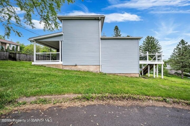 view of side of home featuring a lawn