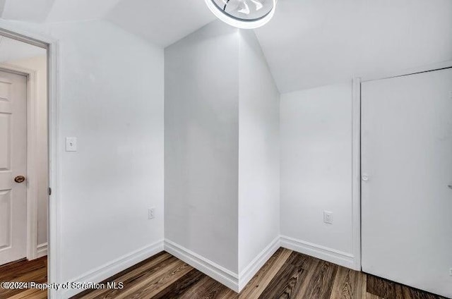 empty room featuring hardwood / wood-style flooring and lofted ceiling