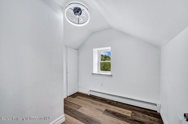 bonus room featuring a baseboard radiator, vaulted ceiling, and light hardwood / wood-style floors