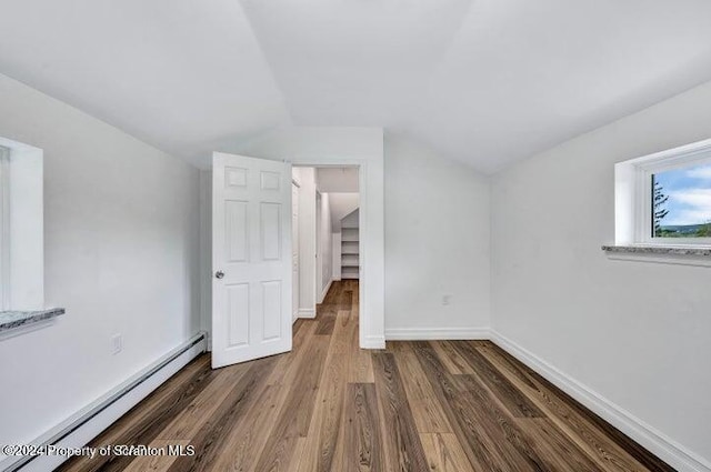 bonus room featuring dark wood-type flooring, a baseboard radiator, and lofted ceiling