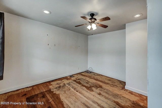 empty room with baseboards, ceiling fan, wood finished floors, and recessed lighting