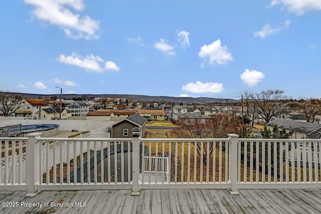 deck featuring a mountain view and a residential view