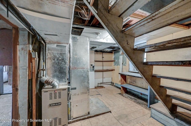 unfinished below grade area with heating unit and stairs