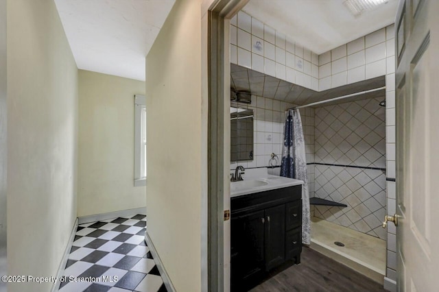 bathroom with visible vents, a tile shower, tile patterned floors, and vanity