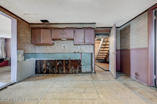 kitchen with a wainscoted wall and wooden walls