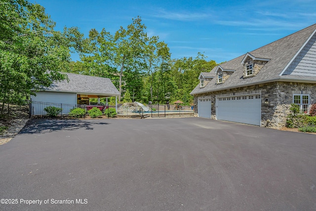 1000 Scenic Dr Unit L 34, Clarks Summit, PA 18411 - view of property exterior featuring a garage, driveway, and stone siding