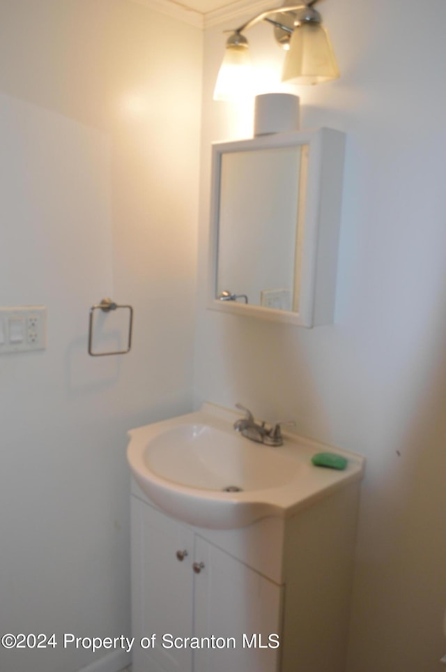 bathroom with vanity and crown molding