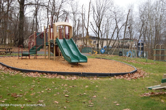 view of jungle gym featuring a lawn