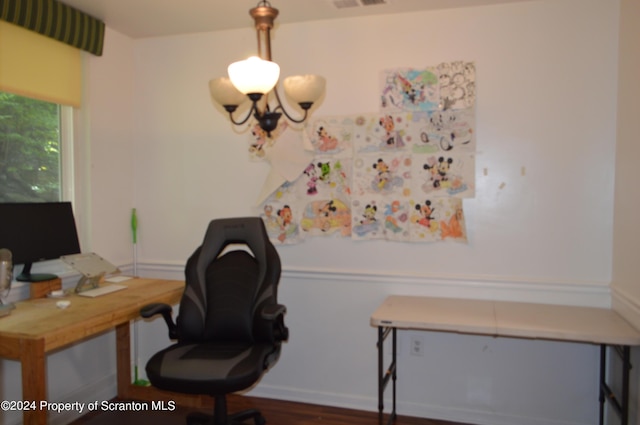 home office featuring dark hardwood / wood-style flooring and an inviting chandelier