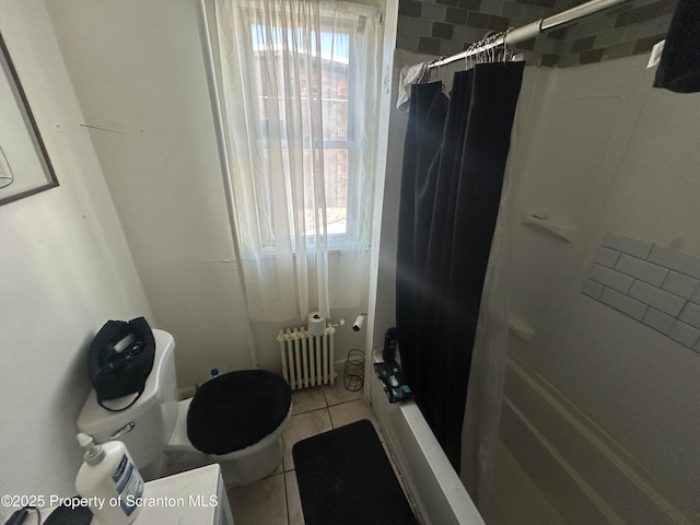 bathroom featuring toilet, radiator heating unit, tile patterned floors, and shower / tub combo