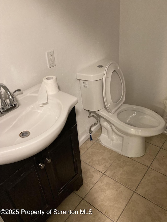 bathroom with vanity, toilet, and tile patterned floors