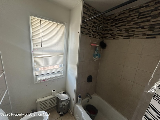 bathroom with tile patterned floors and tiled shower / bath