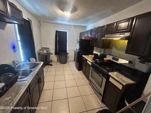 kitchen featuring sink, light tile patterned flooring, black appliances, and a textured ceiling