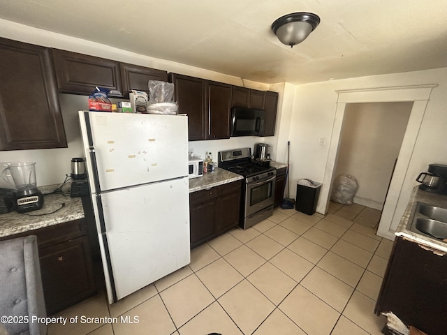 kitchen with white appliances, light tile patterned floors, and dark brown cabinetry