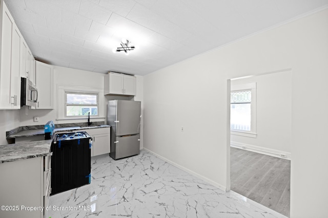 1303 Main St, Pittston, PA 18640 - kitchen featuring stainless steel appliances, white cabinets, light marble finish floors, and ornamental molding