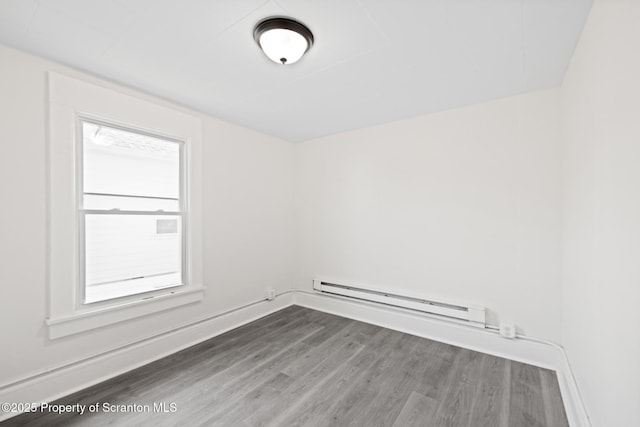 1303 Main St, Pittston, PA 18640 - spare room featuring baseboard heating and dark wood-style floors