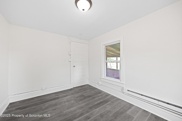 1303 Main St, Pittston, PA 18640 - empty room with a baseboard radiator and dark wood-style floors