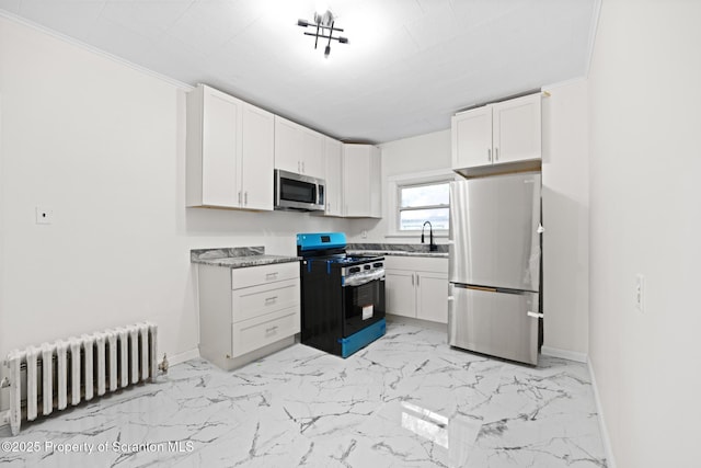 1303 Main St, Pittston, PA 18640 - kitchen featuring stainless steel appliances, radiator, white cabinets, and light marble finish floors