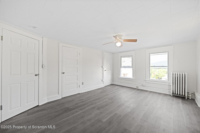 1303 Main St, Pittston, PA 18640 - unfurnished bedroom featuring radiator, dark wood-style floors, and ceiling fan