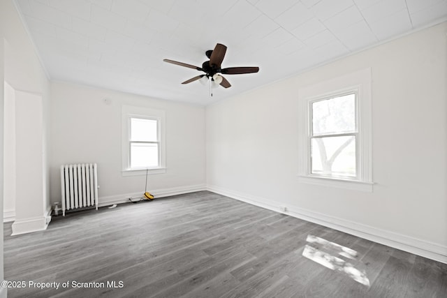 1303 Main St, Pittston, PA 18640 - spare room featuring radiator heating unit, ceiling fan, wood finished floors, and crown molding