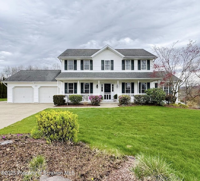 colonial-style house with a porch, concrete driveway, an attached garage, and a front lawn