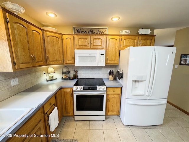 kitchen featuring white appliances, light tile patterned floors, brown cabinets, decorative backsplash, and recessed lighting
