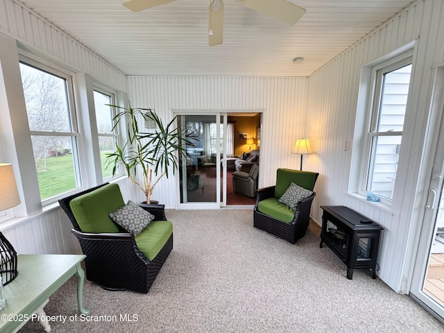 sunroom featuring a ceiling fan
