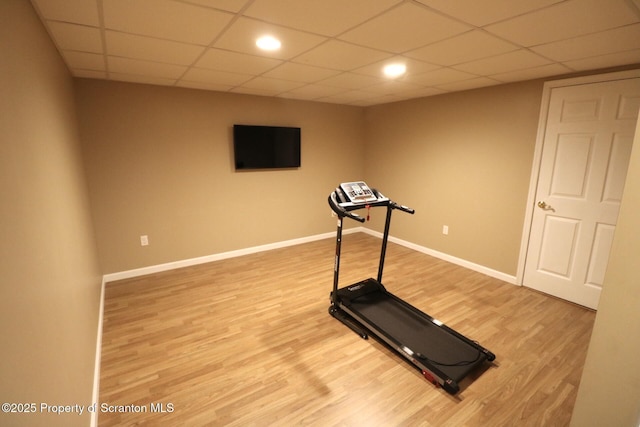 exercise area with wood finished floors, baseboards, a paneled ceiling, and recessed lighting