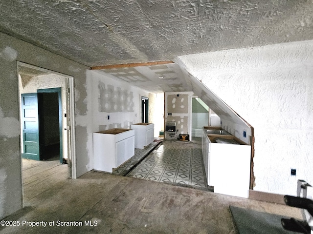 kitchen with vaulted ceiling and independent washer and dryer