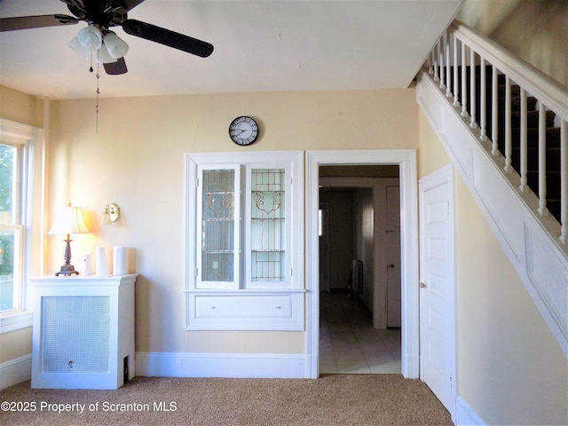 corridor featuring light colored carpet