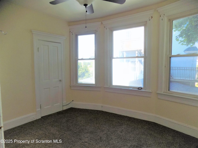 carpeted spare room with ceiling fan