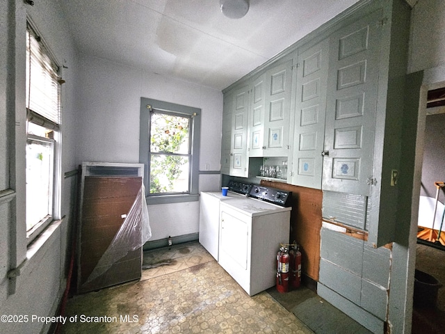 clothes washing area featuring separate washer and dryer