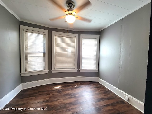 unfurnished room with crown molding, dark hardwood / wood-style floors, and ceiling fan