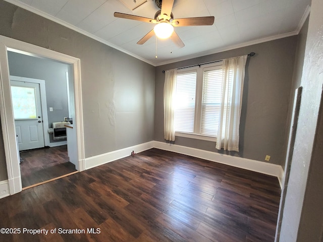 spare room with crown molding, dark hardwood / wood-style floors, and a wealth of natural light