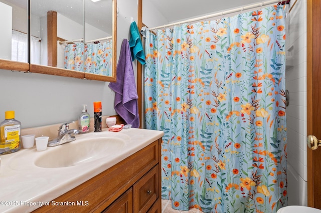 bathroom featuring curtained shower and vanity