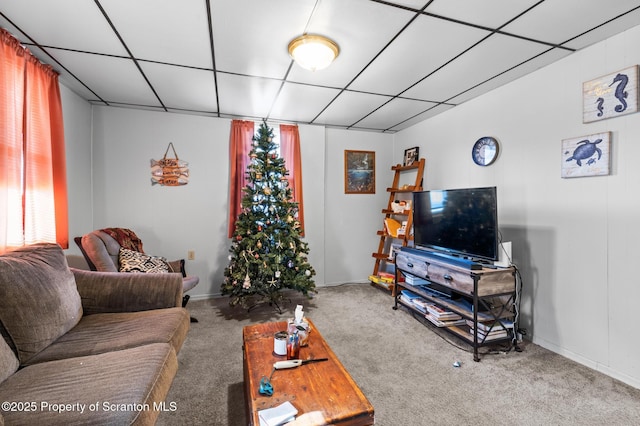 carpeted living area featuring a paneled ceiling